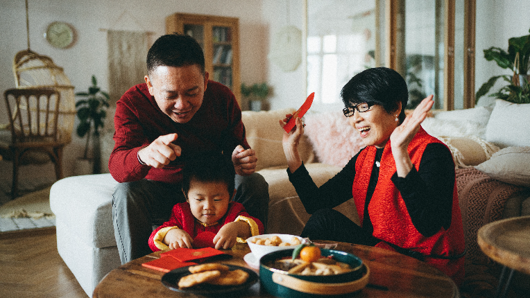 Grandparents playing with child.